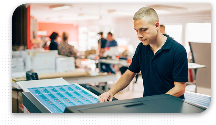 Young man working in printing factory.