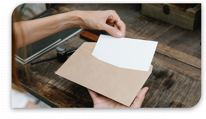 Young Women sit at table opens envelope with letter